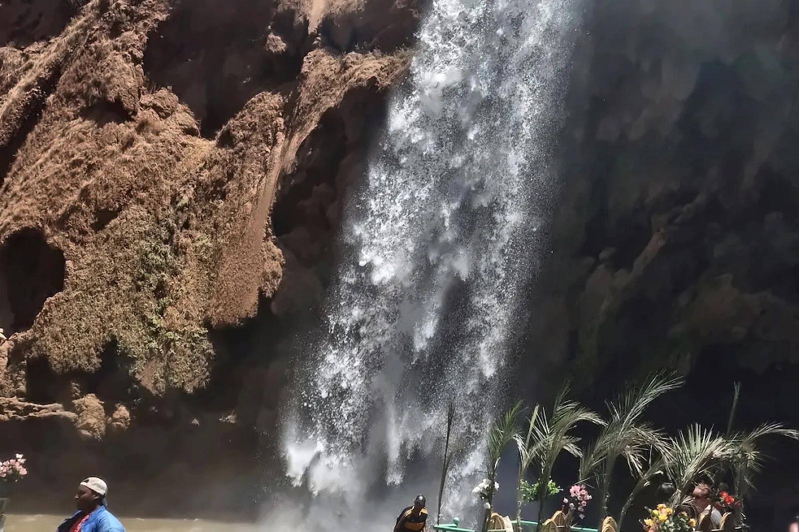 Una barca sotto il salto delle cascate di Ouzoud
